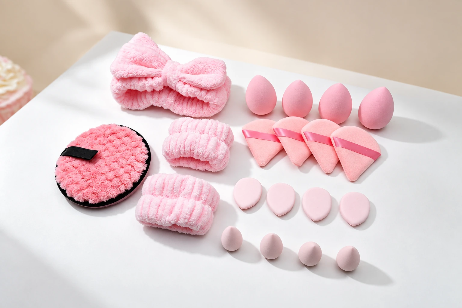 Pink makeup sponges, powder puffs, and beauty headband collection